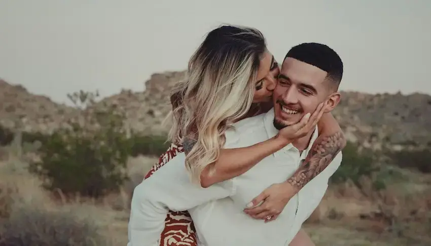 A man and a woman hugging in the desert